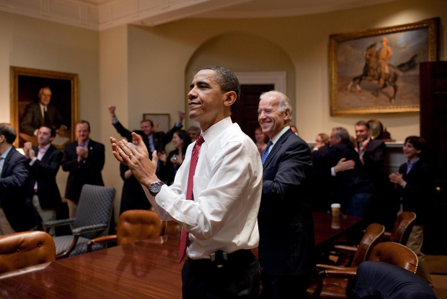 President Barack Obama and his team applaud as they watch the House pass the Patient Protection and Affordable Care Act (Courtesy of Barack Obama Presidential Library)